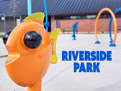 Photo of splash pad at riverside park with a close-up of the cute fish